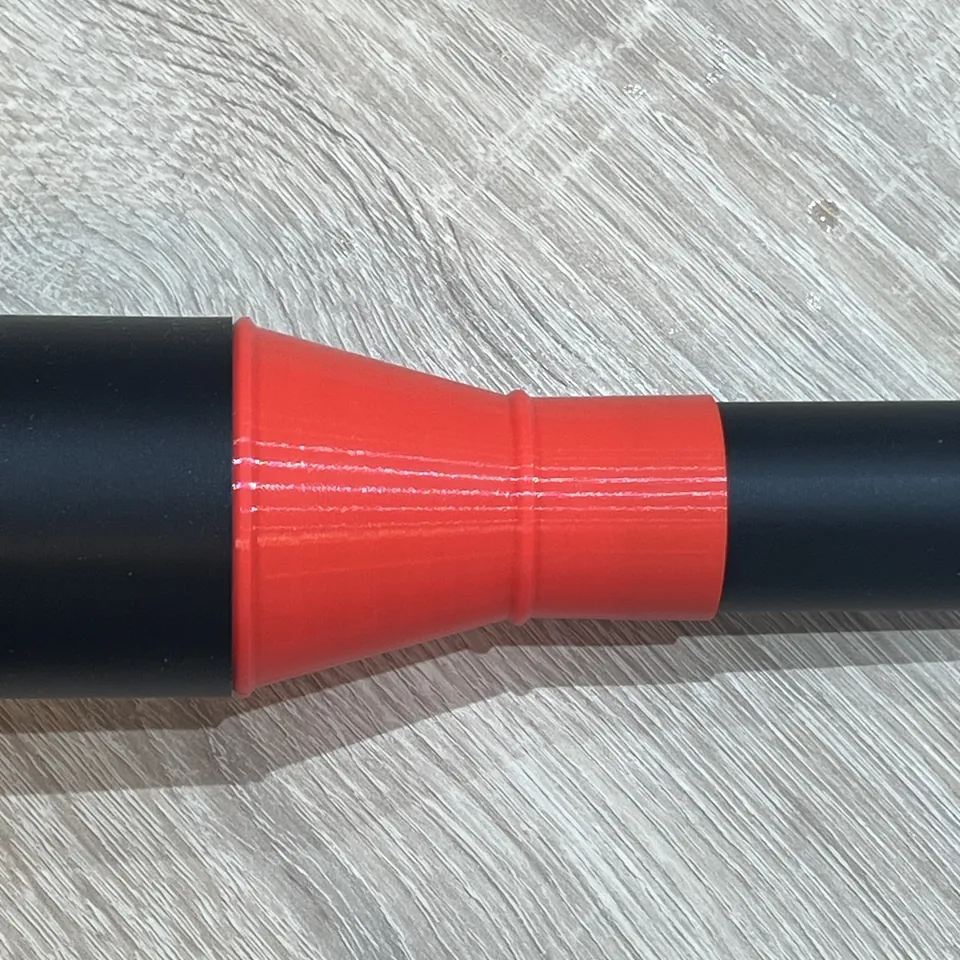 Dust collection adapter - Red adapter fitted between two black pipes of different diameters